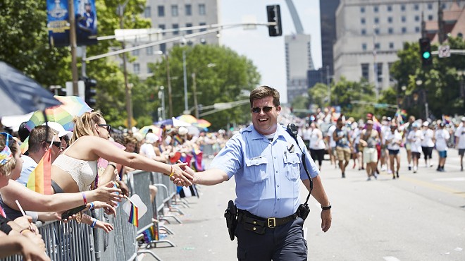 A police officer marches in the 2019 Pride St. Louis parade.