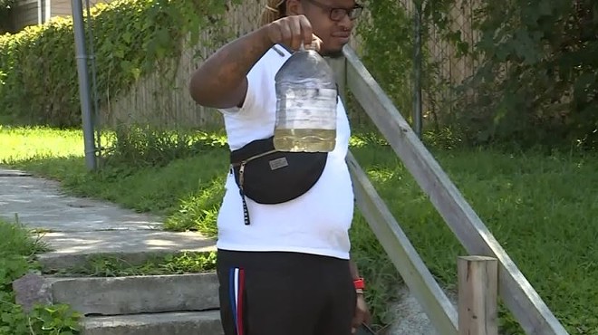 Lamar Conner holds up a bottle of gasoline he says was used in a terrifying home invasion.
