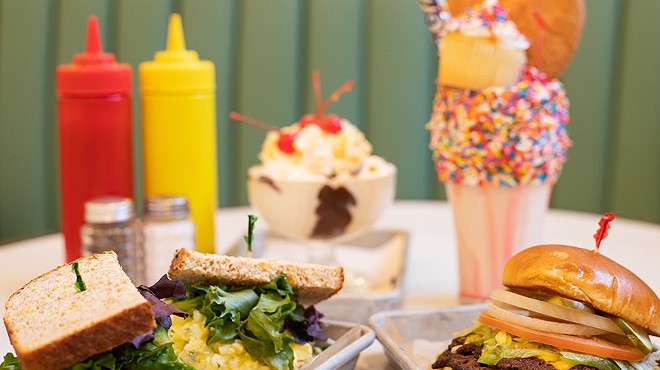 A selection of items from the Soda Fountain, pictured from left to right, top to bottom: egg salad sandwich, double cheeseburger, All-American Sundae and A Very Happy Un-Birthday Freak Shake.
