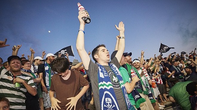 St. Louis soccer fans celebrate Saint Louis FC. The team's fan club supports Props 1 and 2, but the author — a big soccer fan — does not.