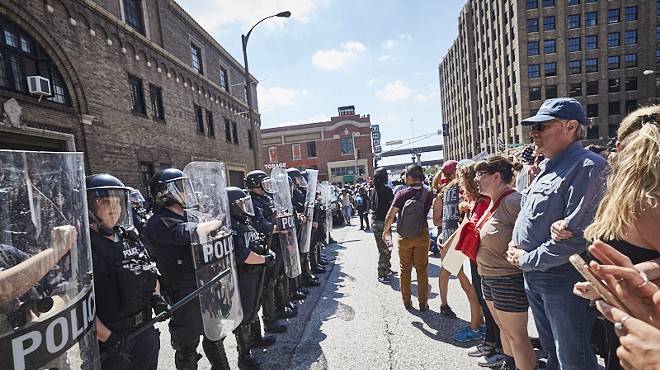 Protesters face off in downtown St. Louis yesterday after the acquittal of a former city cop.