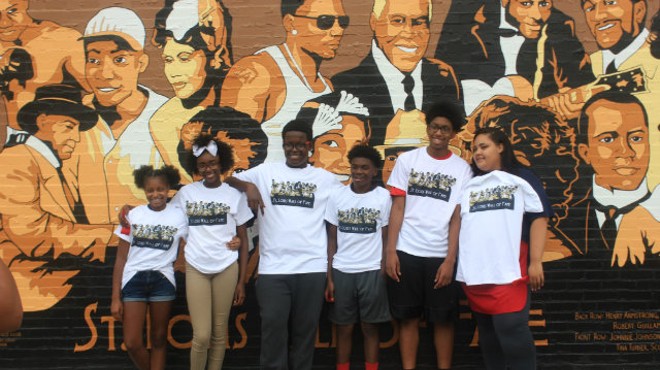 The kids from the Boys and Girls Club pose with the new St. Louis Wall of Fame they created.