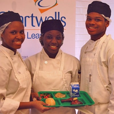The winning team of student chefs in St. Louis' Healthy Schools Campaign Cooking up Change contest pose with their first-place meal.