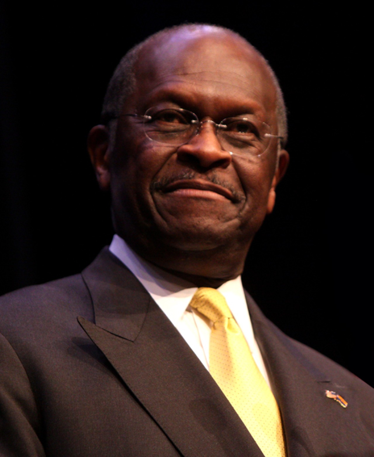Hermain Cain
Did he really think chanting "9-9-9" would solve all of America's problems? Why did he keep quoting the Pokemon movie? Why was Mark Block smoking in his infamous ad? Herman Cain's campaign raised a lot of questions before it was derailed by allegations of sexual promiscuity, but he was undoubtedly one of the more entertaining and original figures of 2012. Please come back in 2016, Herman, we miss you.