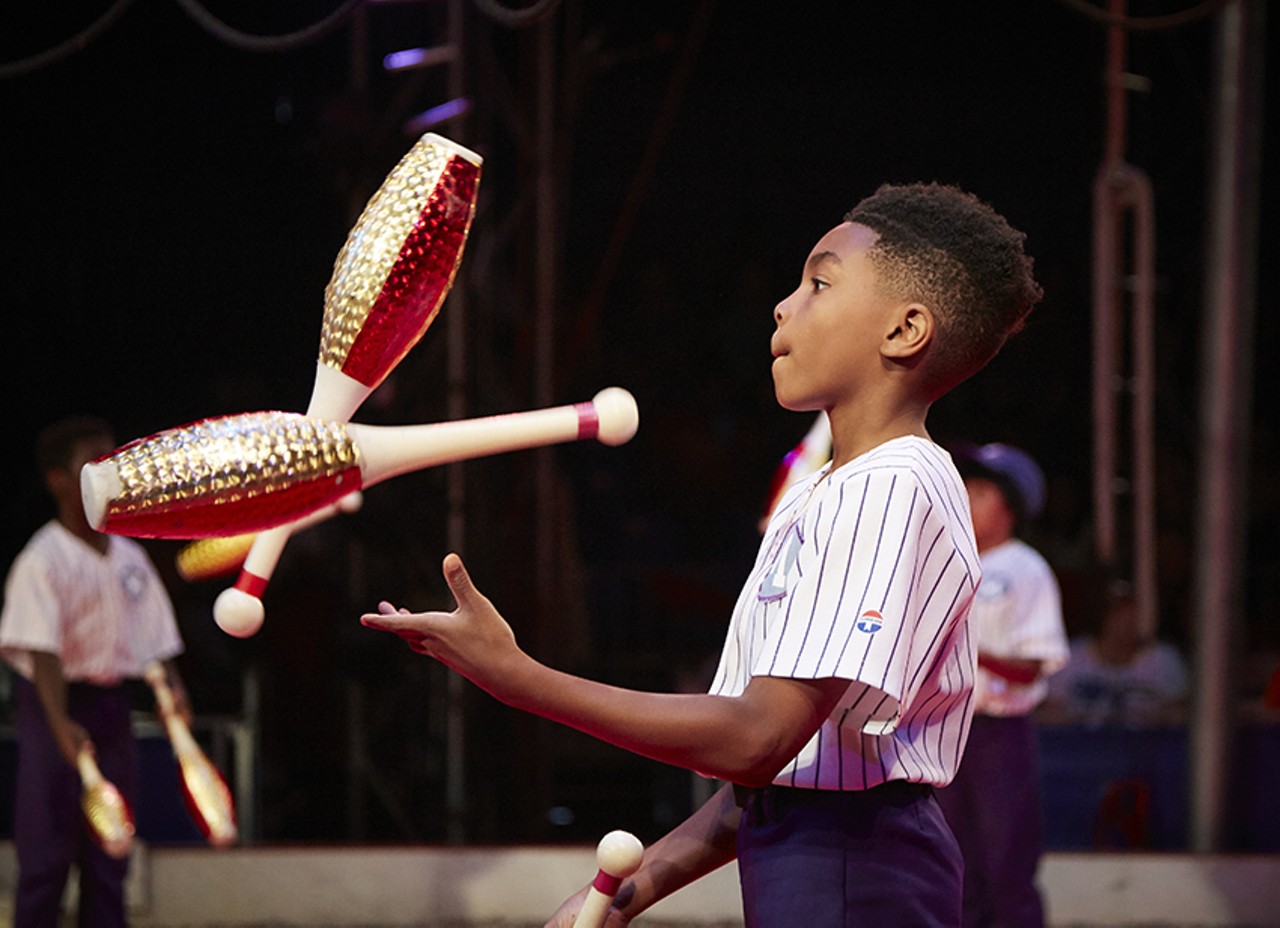 A member of the St. Louis Arches, a local youth circus troupe, shows off his juggling skills.