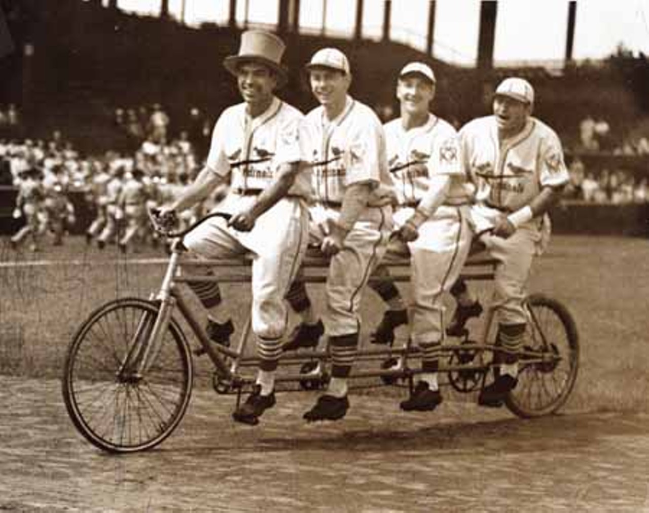 St. Louis Cardinals players on a four-seater bicycle.