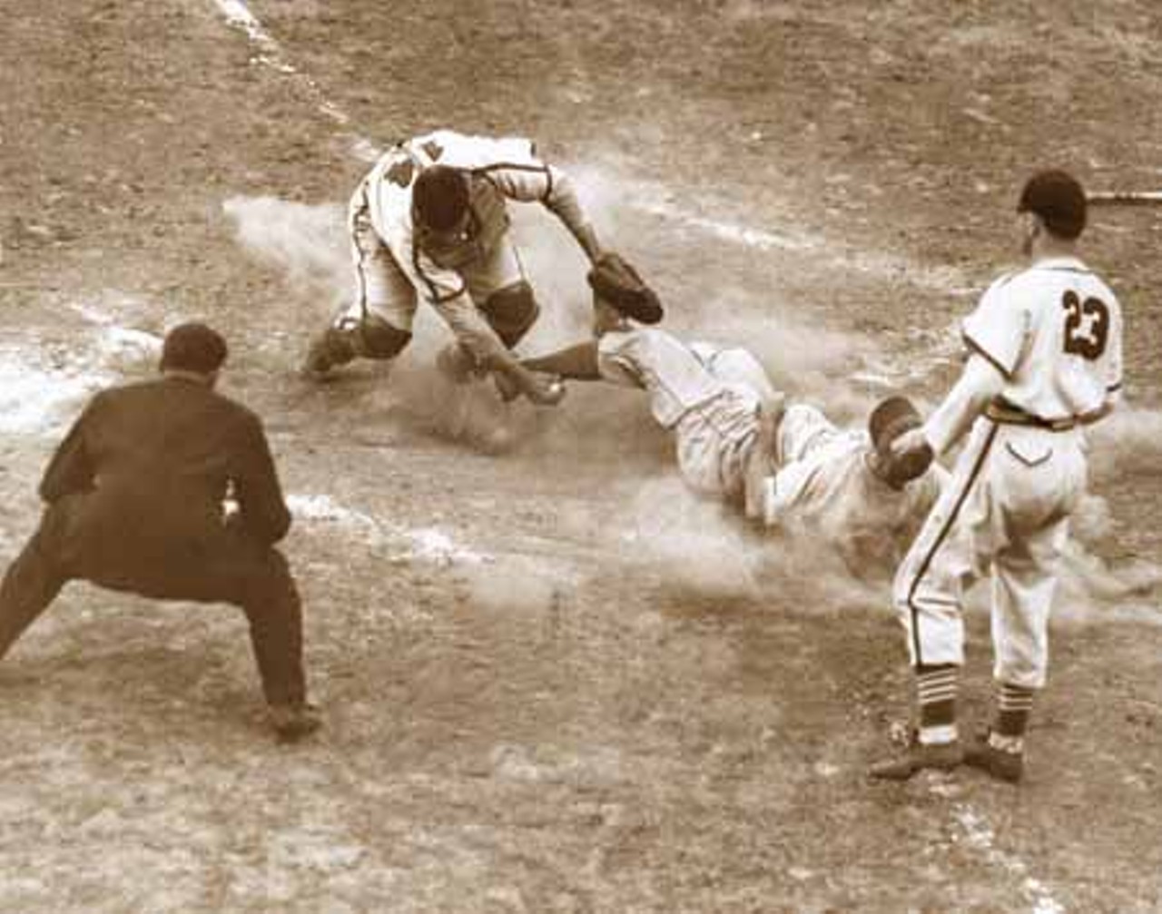 1941. Mickey Owen of the Brooklyn Dodgers is tagged out at home by Gus Mancuso of the Cardinals.