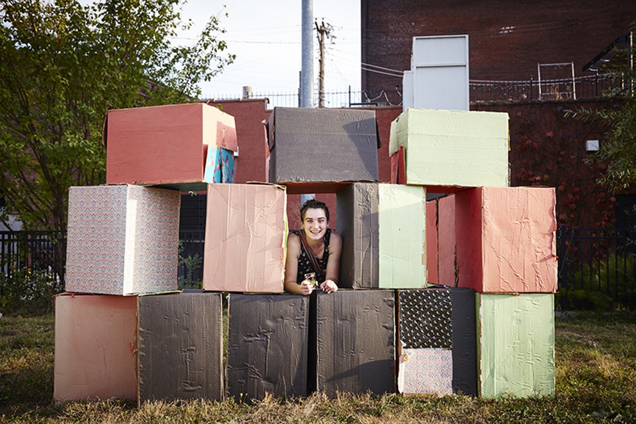 Zoe McKelvie peeks out from a wall of boxes.