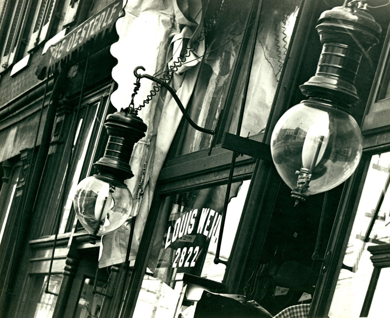 Detail of street lamps outside Louis Weil's Gents' Furnishings shop at 2822 Manchester Avenue. Photograph, 1901.