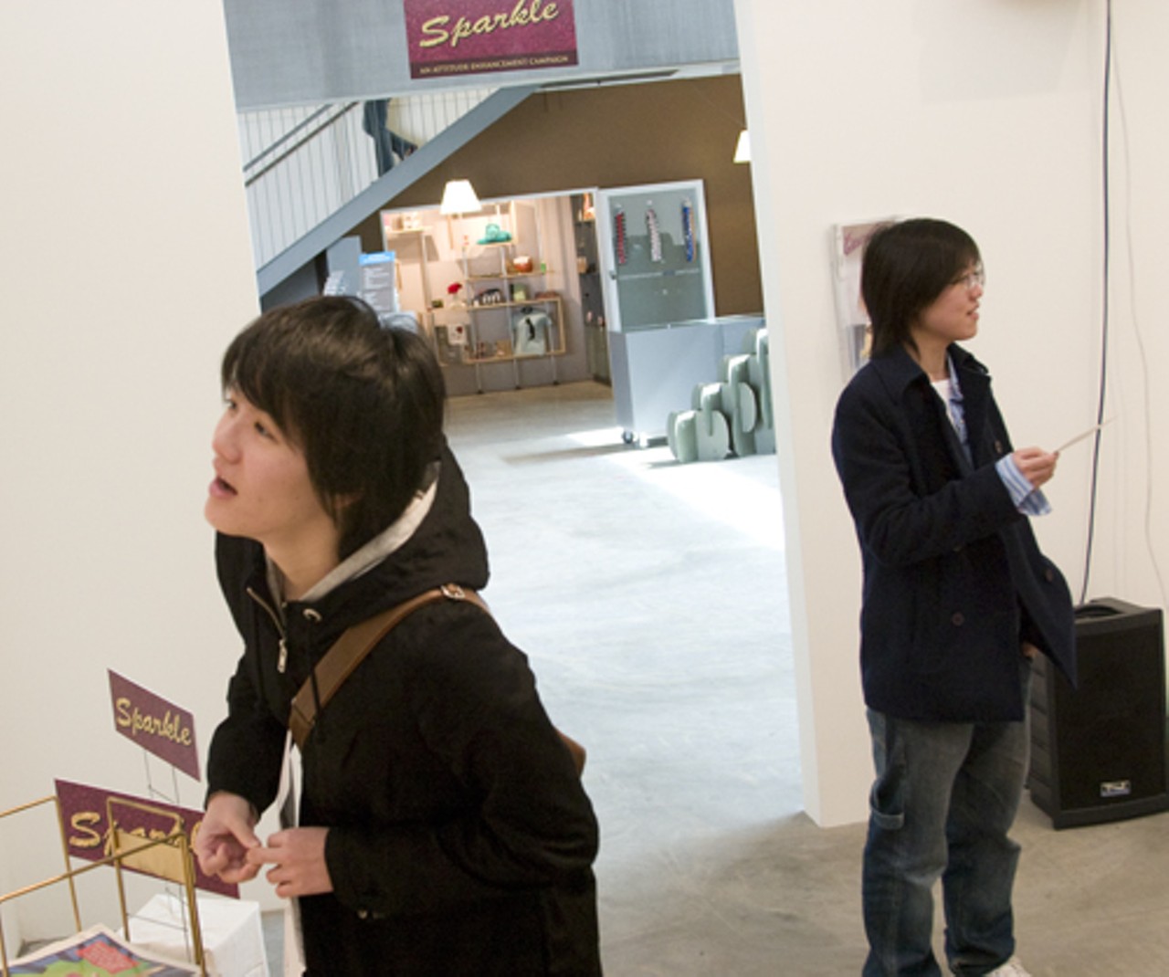 Wil Chiang, left, and Kim Wang who are studying in Champaign, Il from Taiwan scan exhibit.