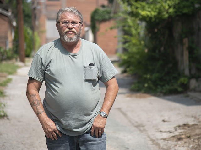 Former St. Louis police detective Roger Murphey poses for a portrait Friday, June 16, 2023, in an alley behind buildings on Shenandoah Avenue.
