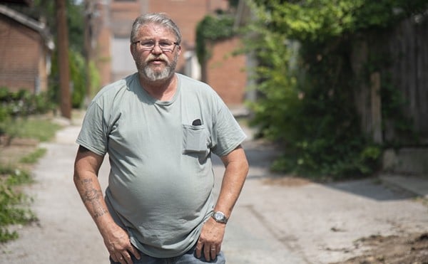 Former St. Louis police detective Roger Murphey poses for a portrait Friday, June 16, 2023, in an alley behind buildings on Shenandoah Avenue.