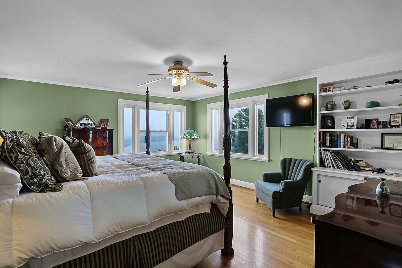 The primary bedroom offers expansive views of the Mississippi.