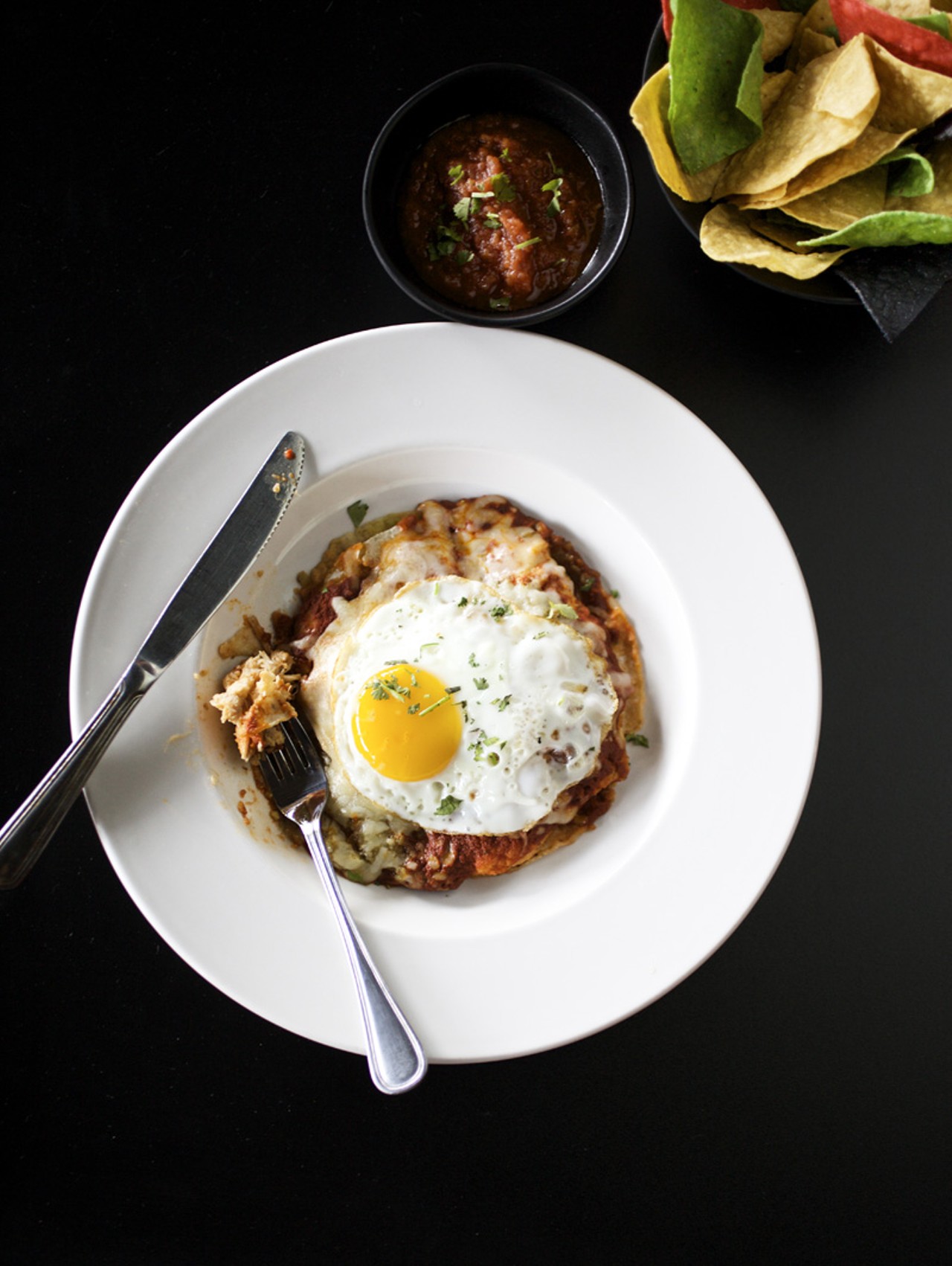 Red's Stacked Enchilada is four layers of corn tortillas with your choice of grilled chicken, shredded beef or smoked pork, served with adobe sauce or green chile. It is then topped with Red's melted cheese blend, and for a dollar more, a fried egg.