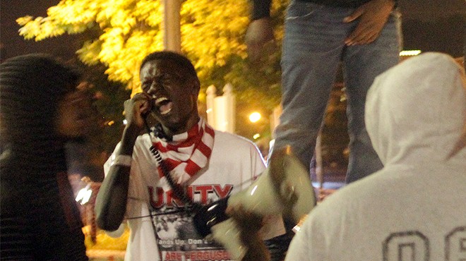 Josh Williams leads a protest chant on September 26, 2014.