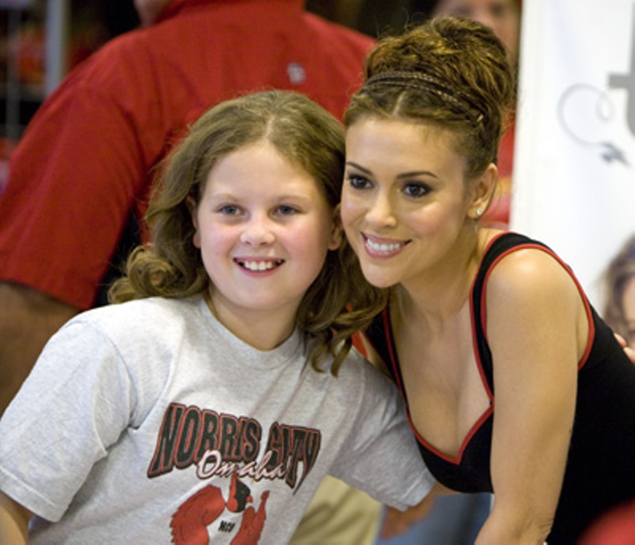Milano poses with a young fan.