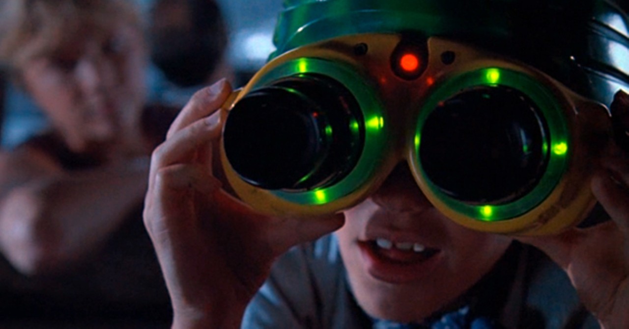 Tim digs up night vision goggles. Like all Spielberg kids, he's enchanted by the wonder of his dangerous situation.