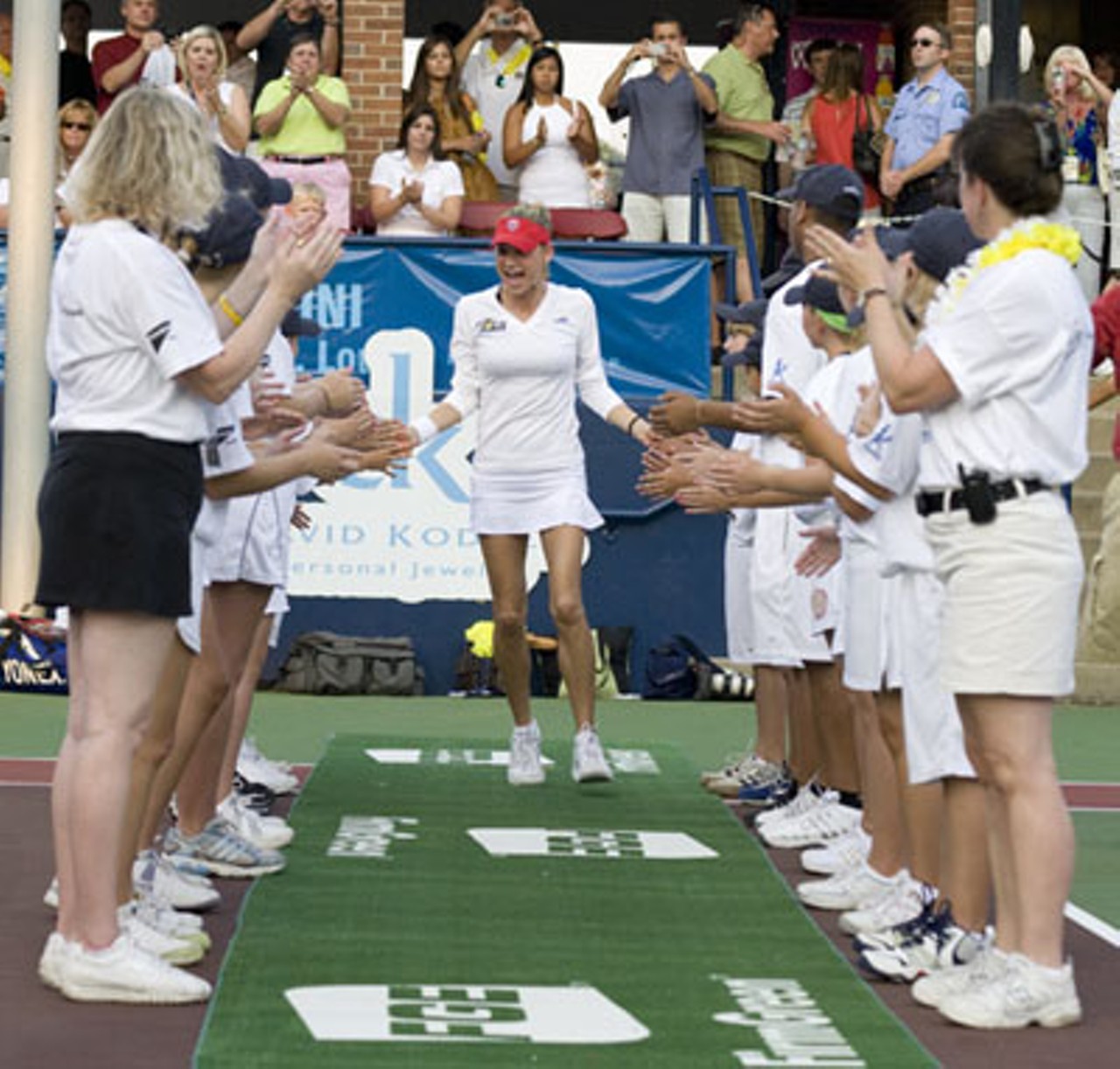Anna Kournikova gets greeted onto the court by a line of high-fives.