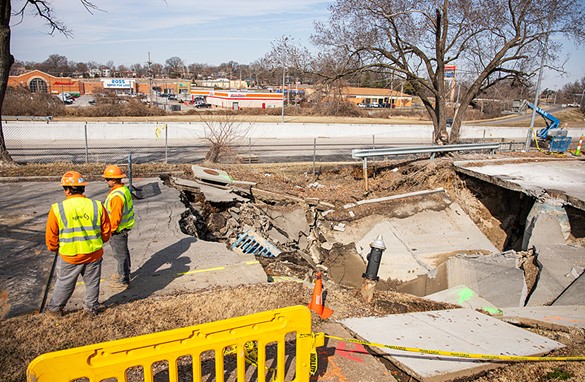 Spire crews stand by a sinkhole that opened up at Idaho Avenue and Blow Street in the Carondelet neighborhood on Wednesday, Feb. 21, 2024.