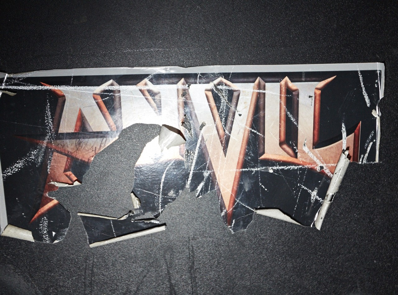 A torn Anvil sticker clings to a roadie case.