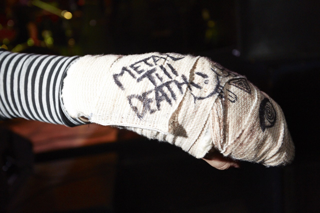 Jennifer Hupp shows off her signed cast emblazoned with the words "METAL TILL DEATH" at the Anvil show on February 19, 2015 at Fubar.