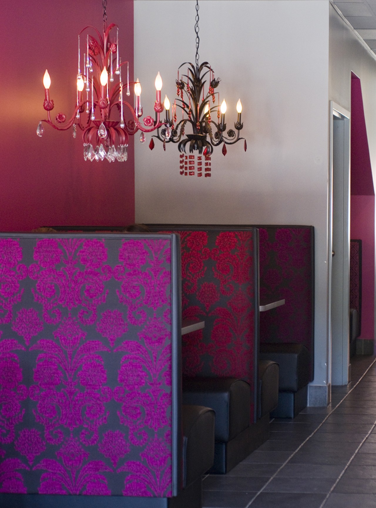 Caf&eacute; Mochi's hip interior, its booths covered in hot-pink brocade woven fabrics.