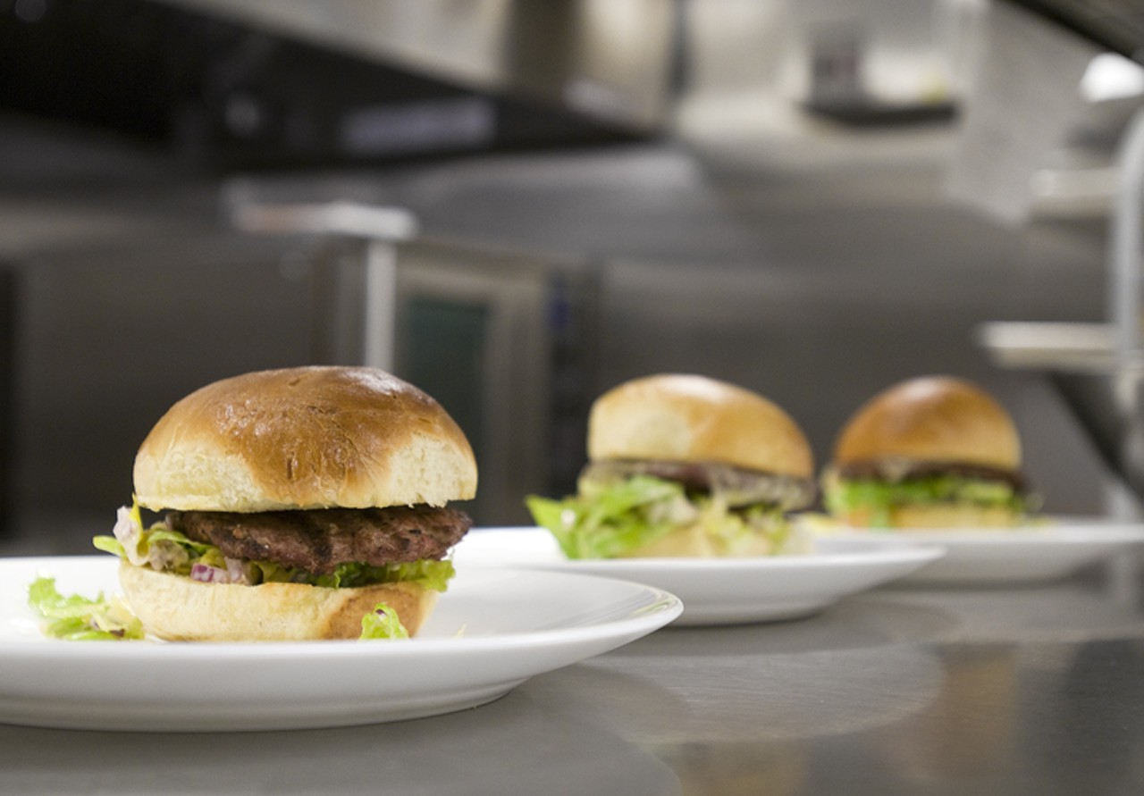 Burgers, under the heat lamps, about to meet with their plate-mate, the fries!