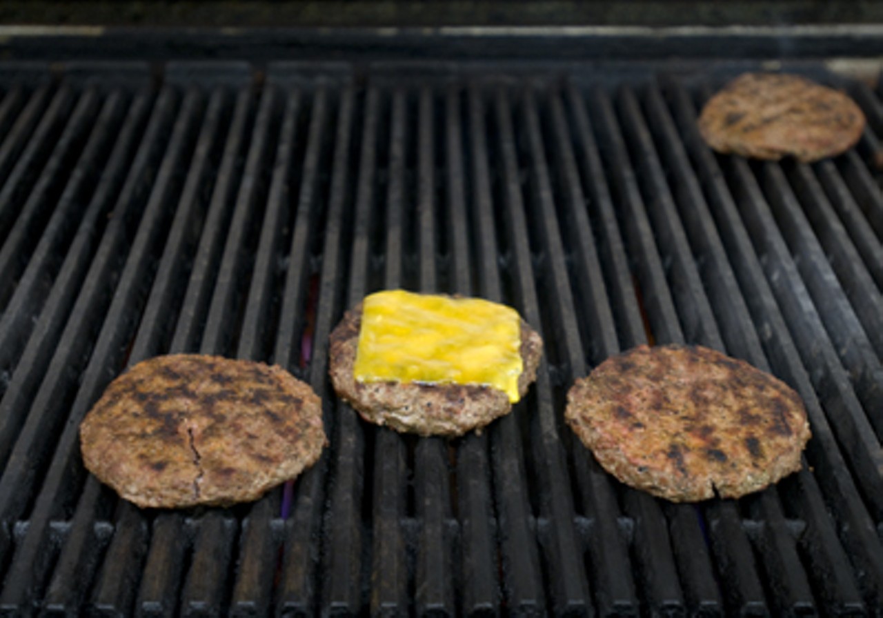 Burgers on the grill at the restaurant, which opened on February 13.