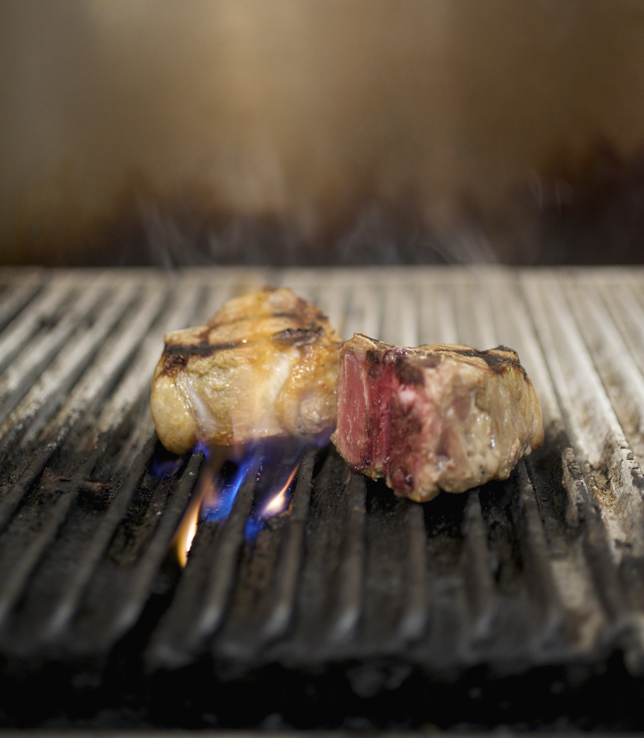 Executive Chef John Buchanan&rsquo;s lamb porterhouse on the grill. He tells me it&rsquo;s a very original cut of meat. He likes taking a classic dish and making it more contemporary.