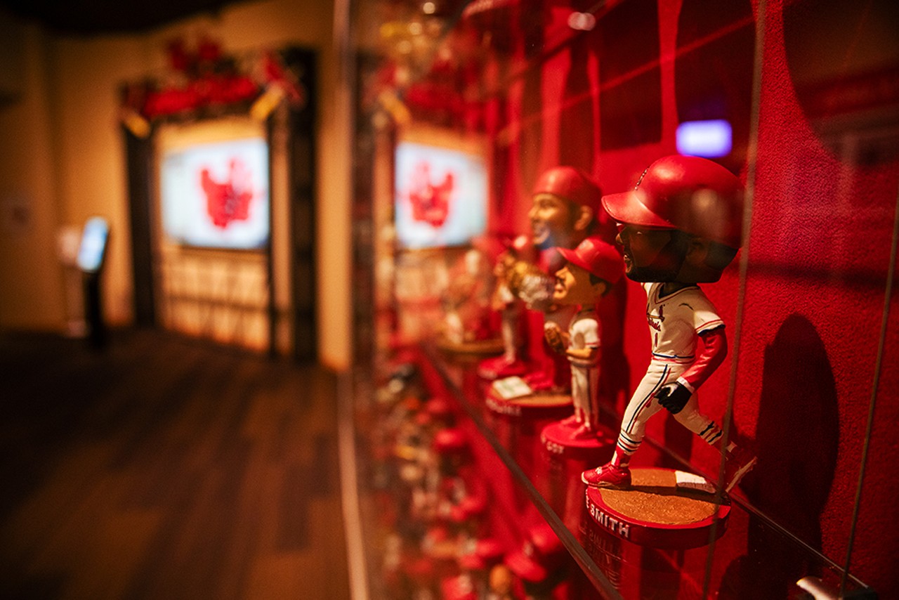 Ozzie Smith sits on a shelf next to other Cardinal bobbleheads inside the St. Louis Cardinals Hall of Fame and Museum at Ballpark Village.