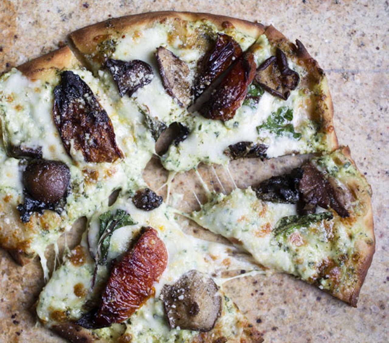 This flatbread pizza is topped with spinach and artichokes and roasted mushrooms.