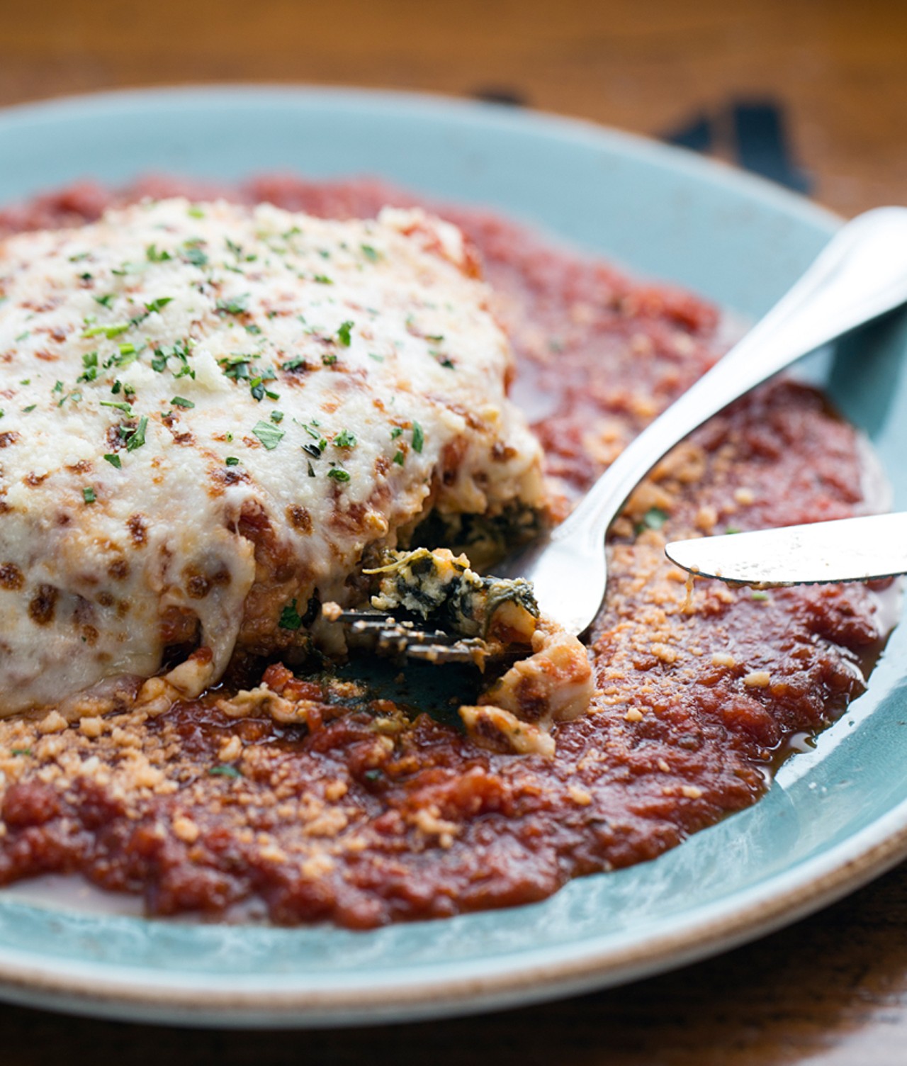 Billy's lasagna brings baked layers of noodles with house bolognese sauce, fresh spinach and parmesan cream blended with ricotta and mozzarella cheeses.
