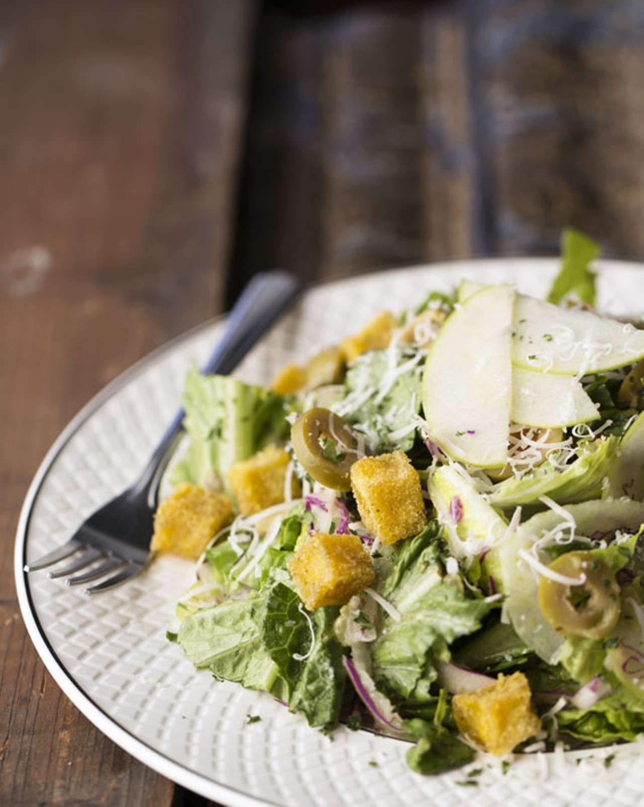 Blind Tiger's house salad, made with romaine, cabbage, fennel, olives and apples, complete with baked-polenta croutons and dill-cucumber vinaigrette.