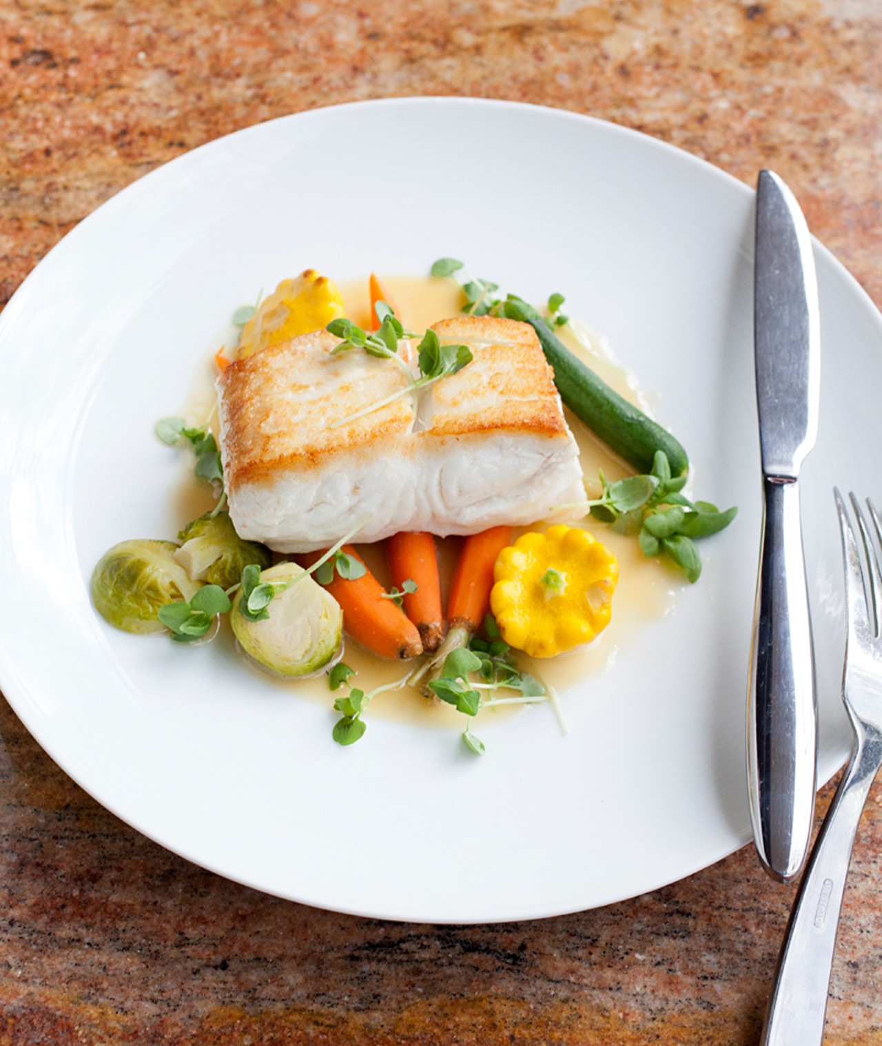 The halibut, braised in white wine with baby vegetables.