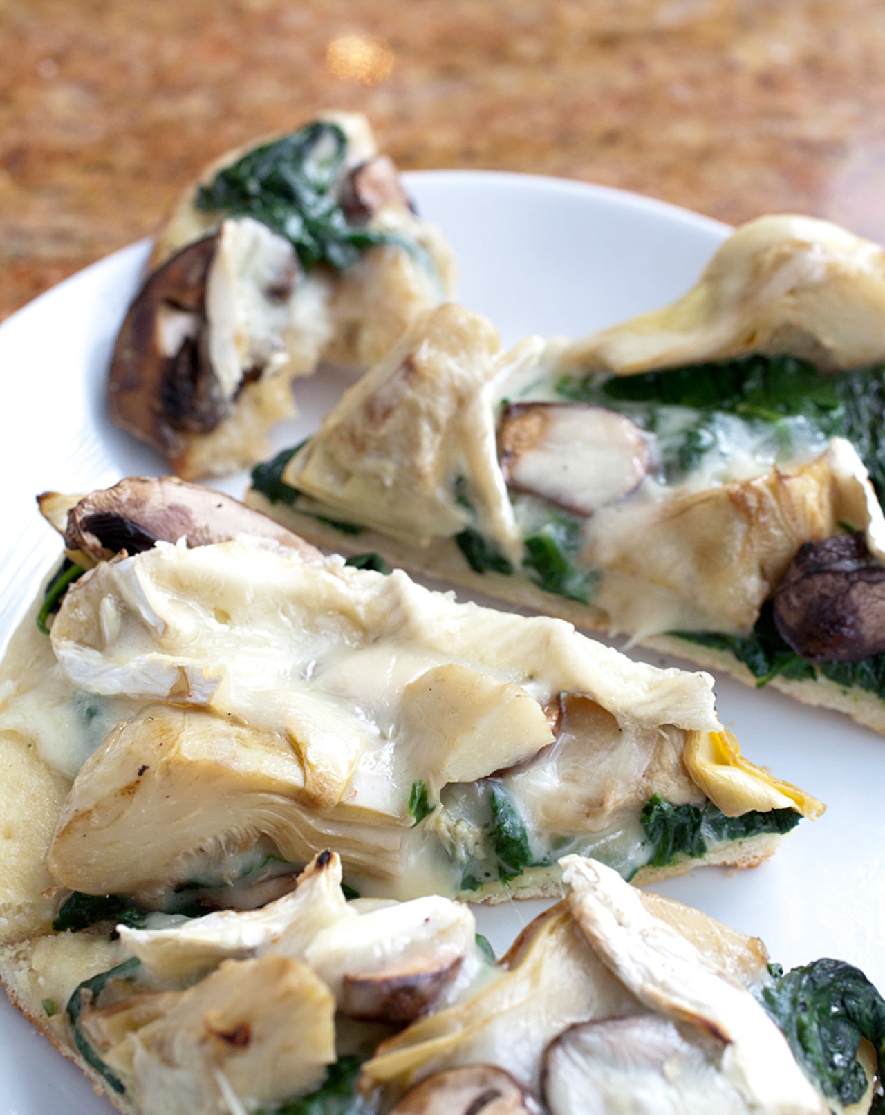 Roasted-artichoke flatbread with portabella mushrooms, spinach and Camembert cheese.