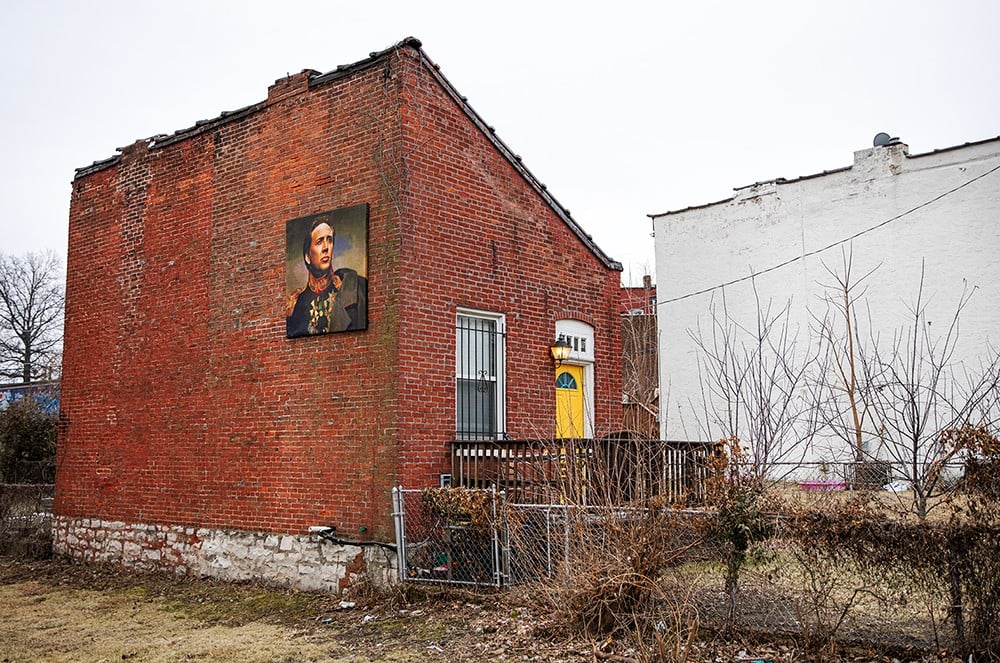A portrait of Nicolas Cage hangs on the outside a home in St. Louis. This portrait was the first Nicolas Cage-themed item that owner Jack Seline installed at the house.