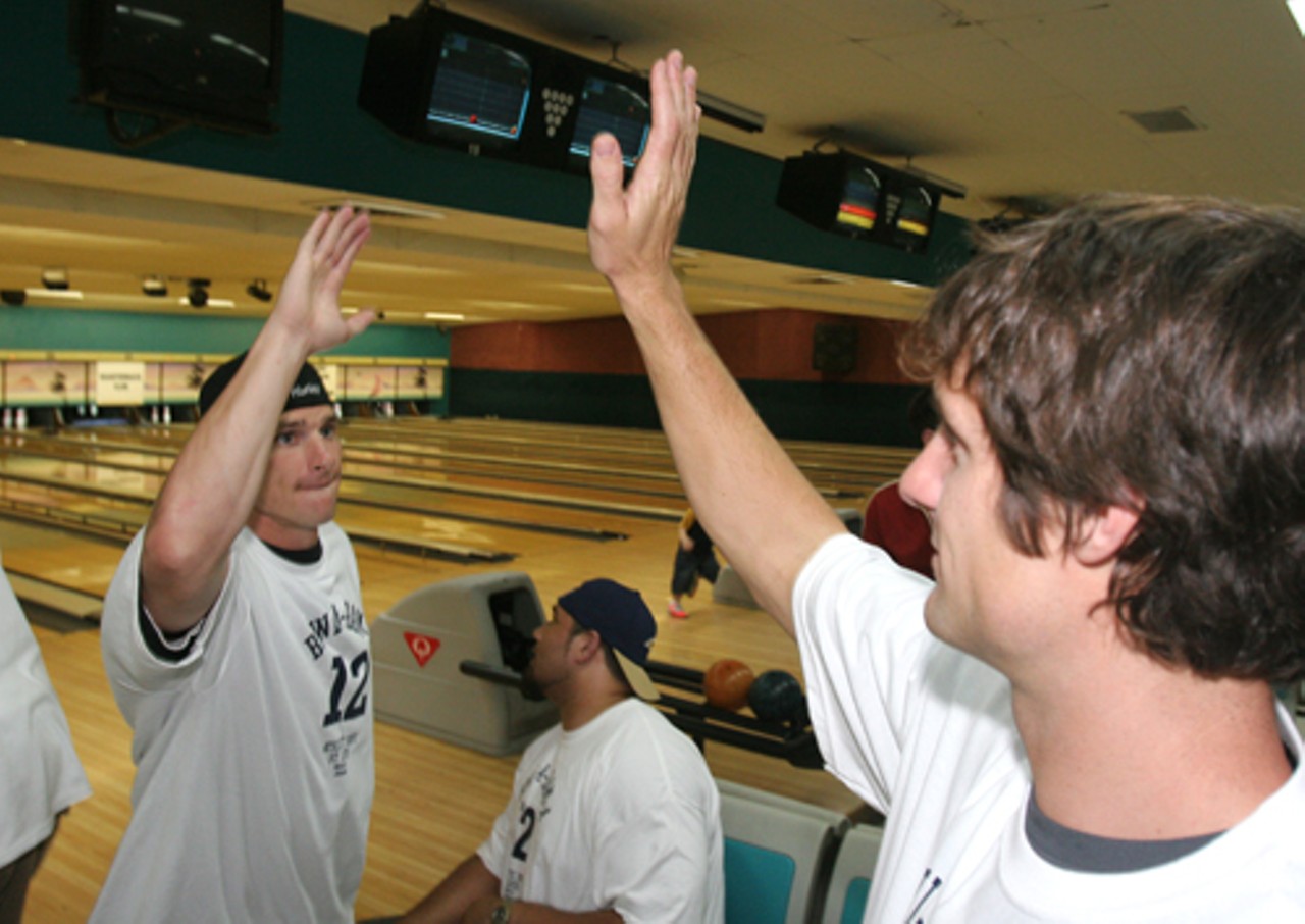 Dane Looker and Drew Bennett high-five after a strike.
