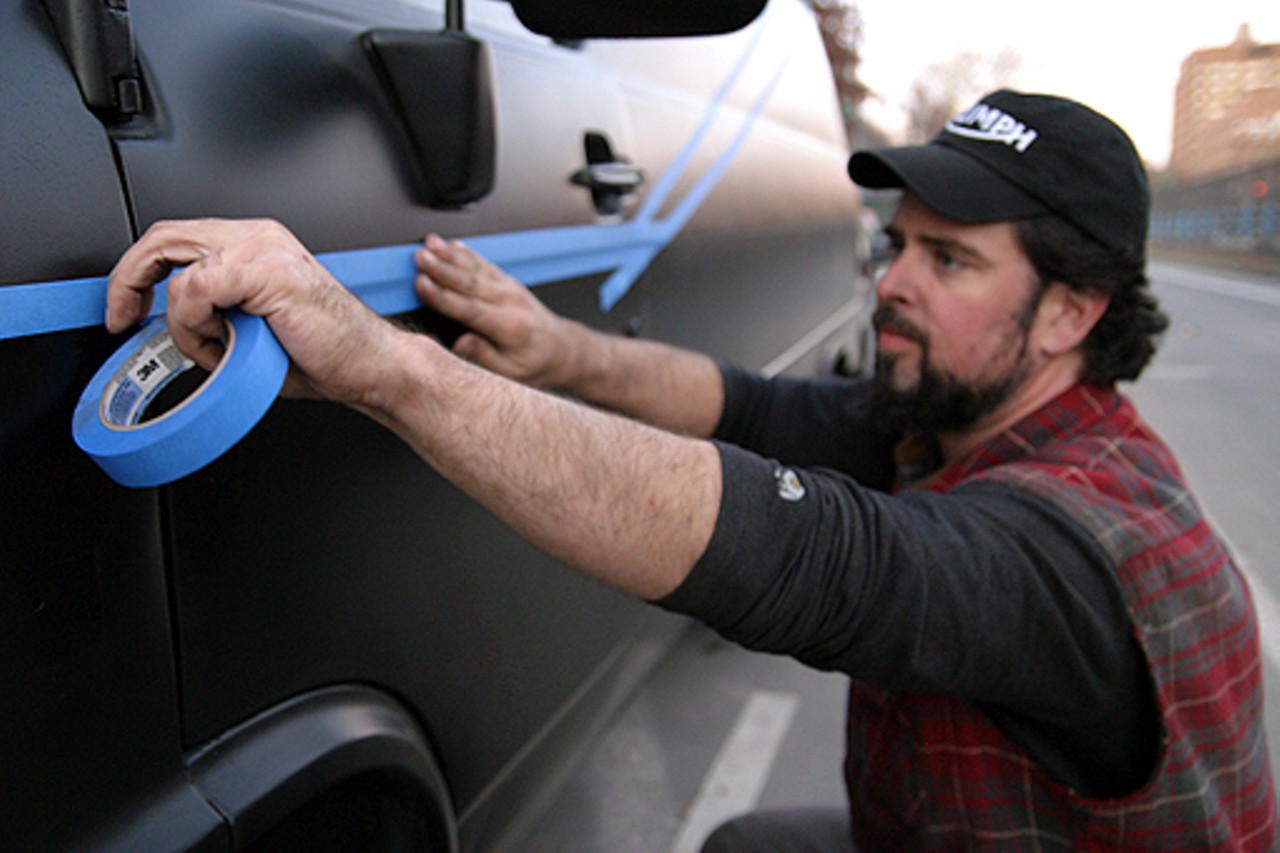 John Ficarra tapes off the red stripe design for the A-Team van.