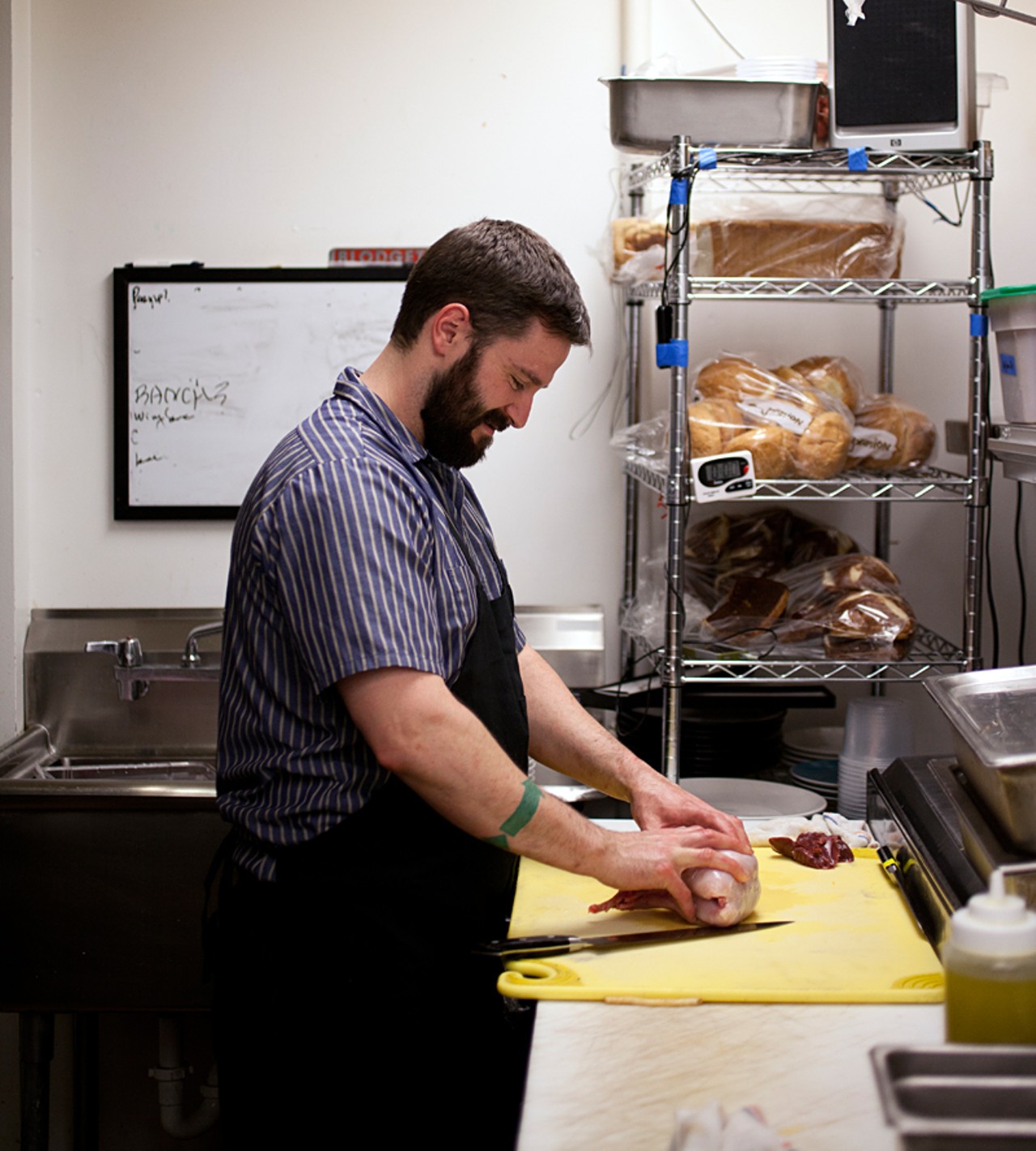 Owner and chef Eric Heath at work on a rabbit in the kitchen of Cleveland-Heath.