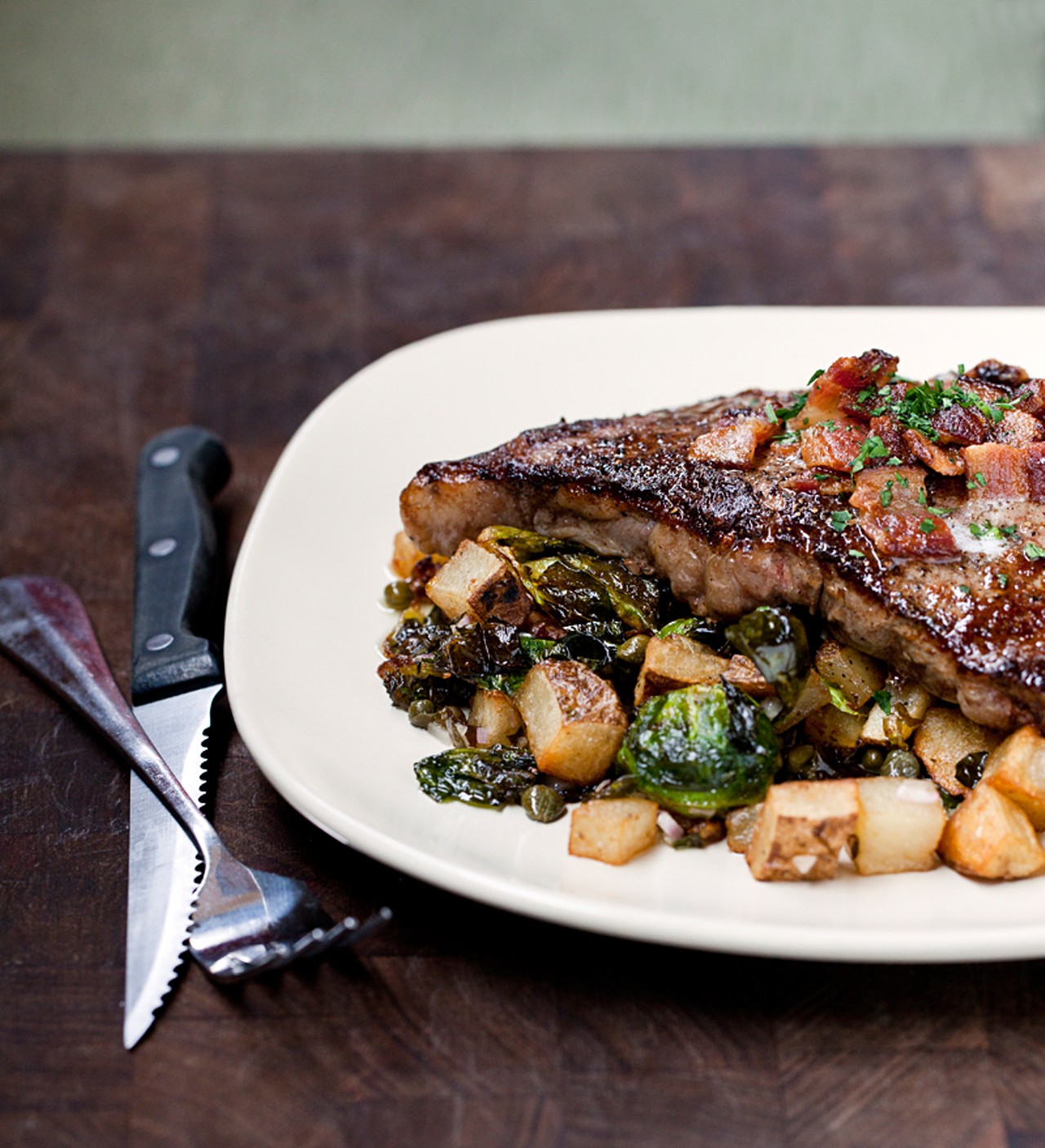 The steak of the day on February 8, 2012, was a ribeye. The steak of the day is served with crispy potatoes, Brussel sprouts and bacon butter.