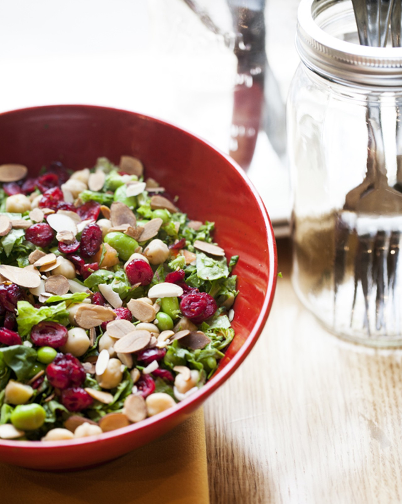The Health Nut is broccoli, edamame, carrots, toasted almonds, dried cranberries and garbanzo beans with spinach and romaine, served with a raspberry vinaigrette.