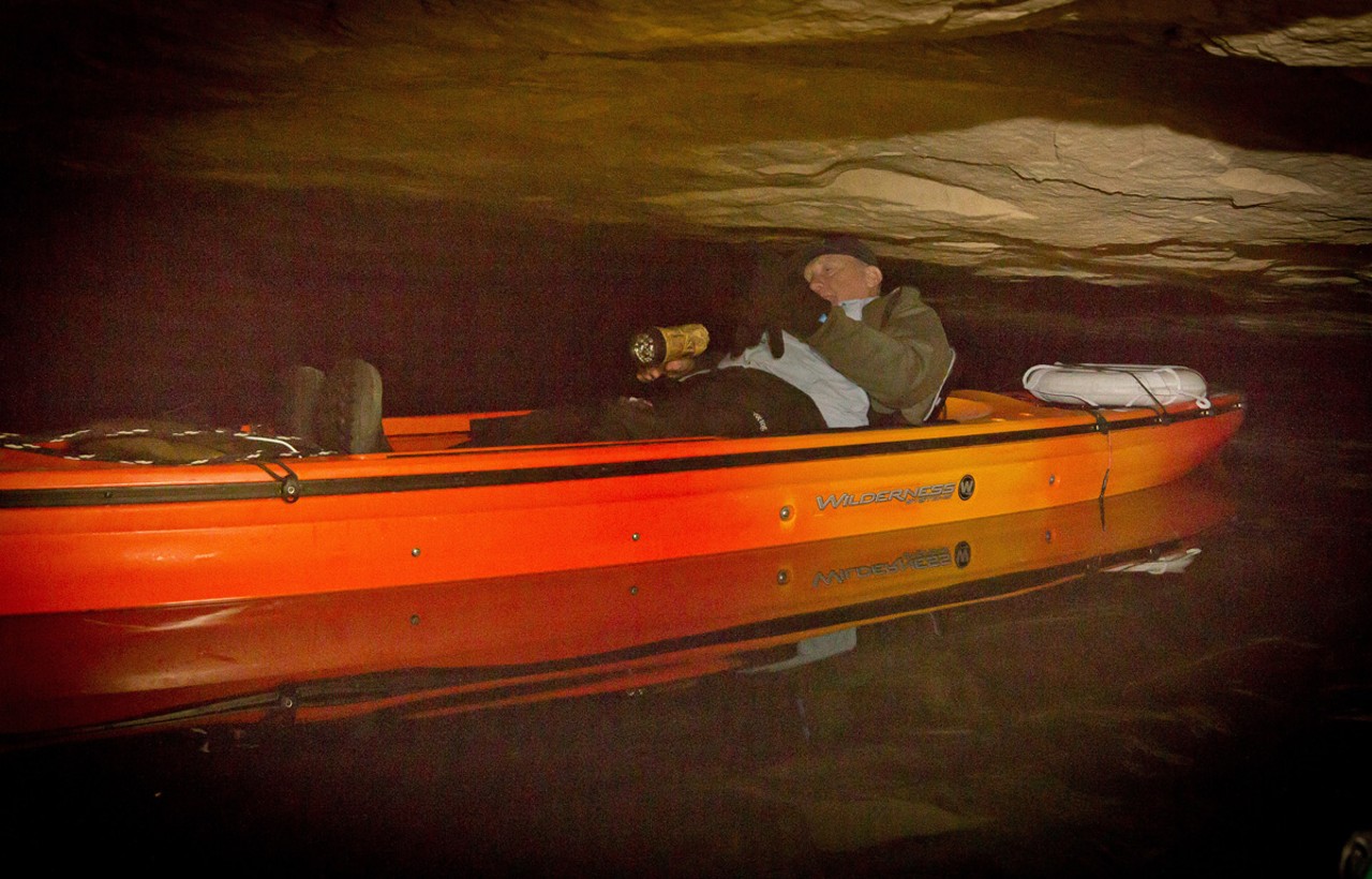 Don Marsan lays down in his kayak to navigate the "Squeeze Tube," a portion of the mine where there is just enough room between the water and the roof for a kayak to slip through.