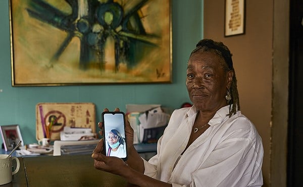 Carolyn Reed with an image of her daughter Chuny Ann Reed, who died in prison.