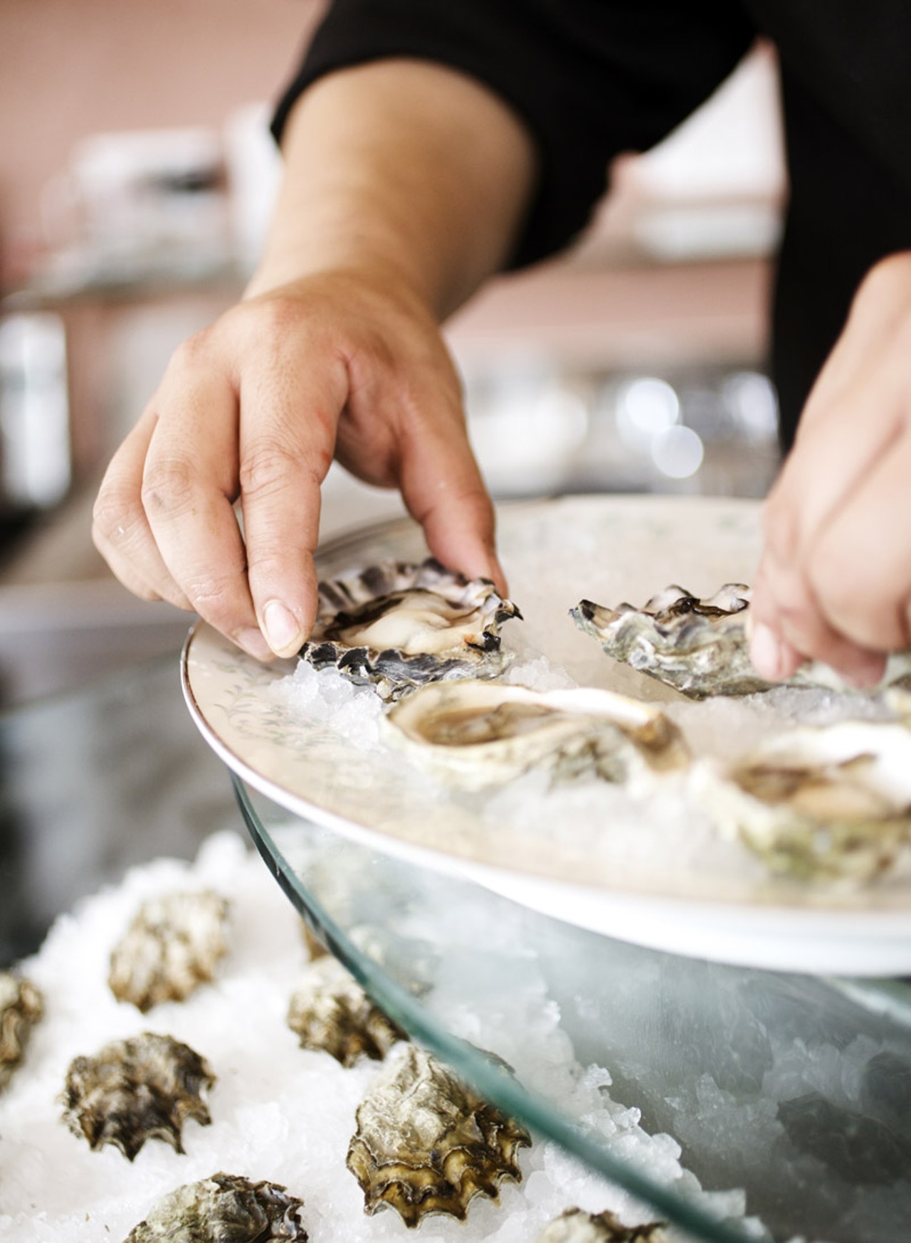 Chef Je Kang plating the fresh oysters.