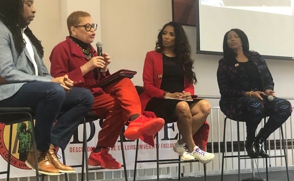 Robin Proudie (right) and attorney Areva Martin (second from right) listen to Dr. Julianne Malveaux, a former college president and board member of the National African American Reparations Commission.