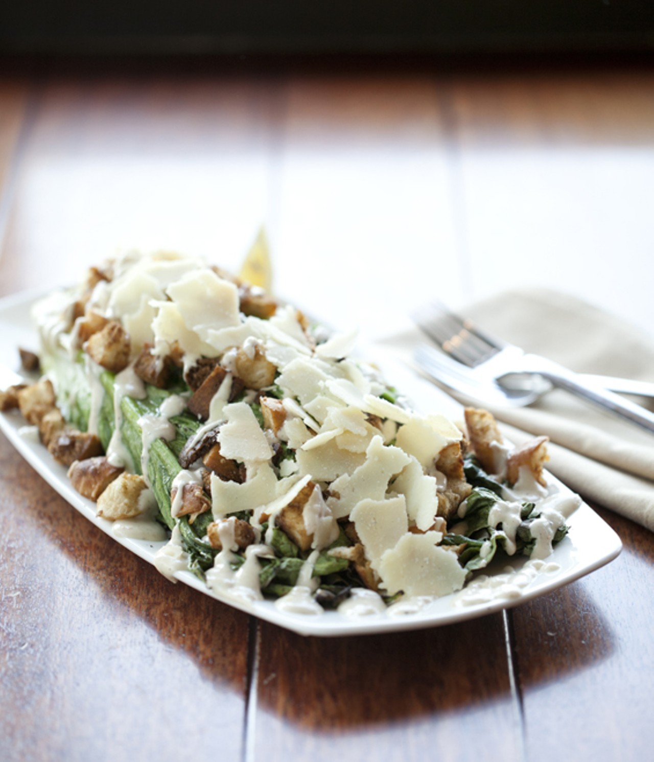 Grilled Caesar Wedge with lemon, fresh cracked pepper, shaved parmesan, garlic roasted croutons and house-made dressing.