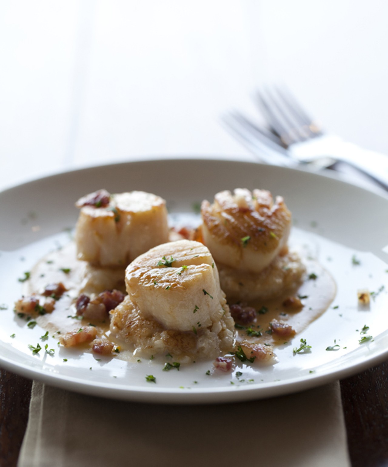 Chardonnay Seared Scallops on rosemary risotto cakes with butternut-maple puree and pancetta.