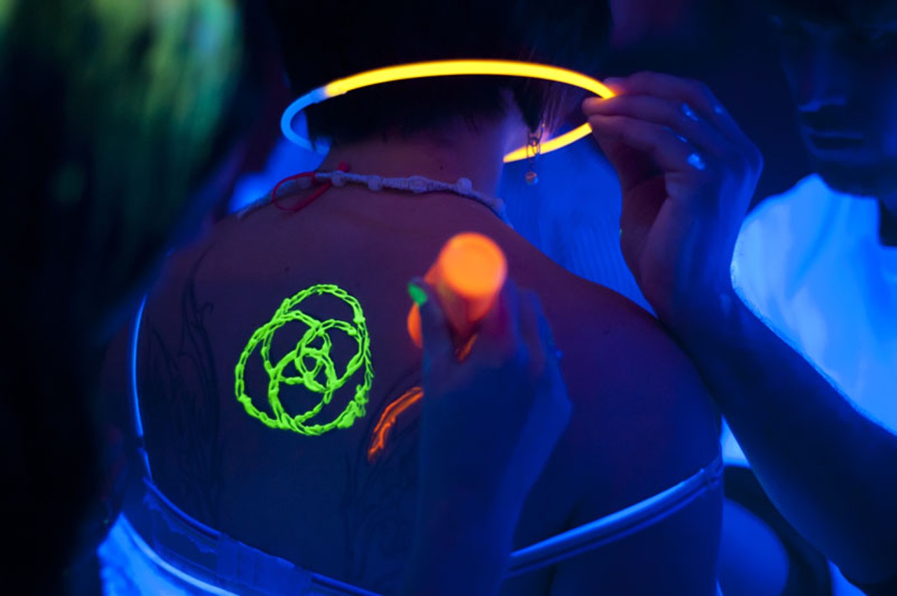 Fellow party-goers help each other out with some glow-in-the-dark paint at the Crack Fox on Saturday night.