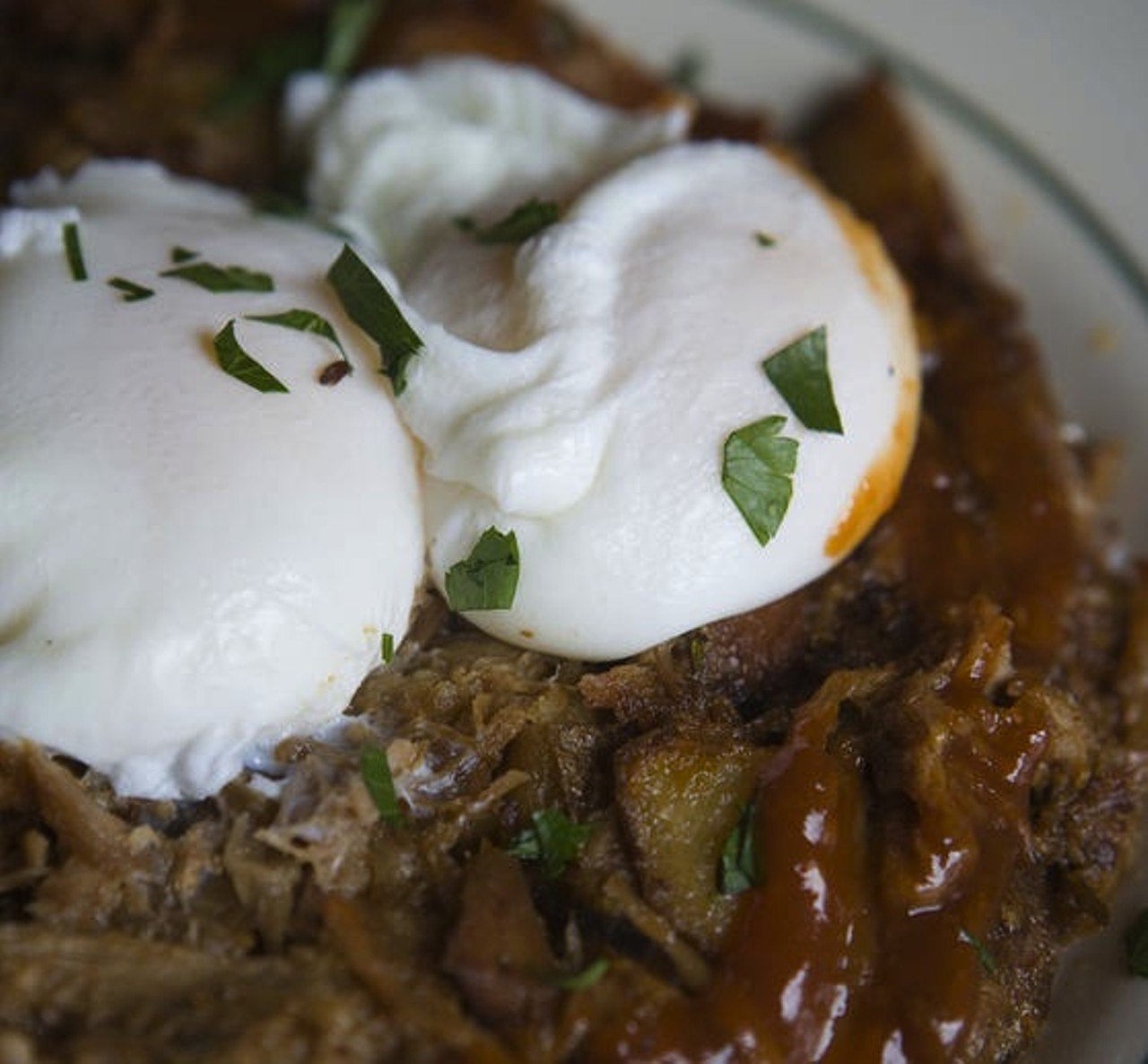 Say good morning to two poached eggs over spicy barbecue pork hash at the Nickel Diner in Los Angeles, California.