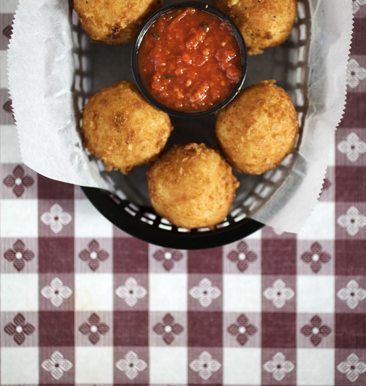 The Arancini appetizer is a Filomena's house specialty. They are housemade risotto croquettes, flash fried with a melted cheese center and served with marinara sauce.
